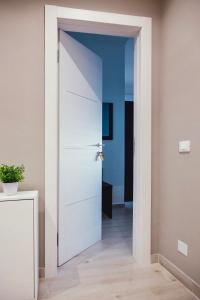 a white door in a room with a hallway at Oasis in Acitrezza