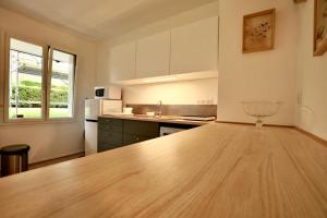 a kitchen with a wooden counter top in a room at Studio Royal de la Plage in Deauville