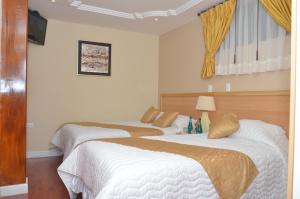 Postel nebo postele na pokoji v ubytování Kuna Hotel