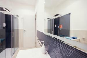 a bathroom with a mirror and a sink at Oasis in Acitrezza