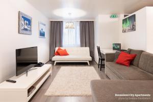 a living room with a couch and a tv at Rovaniemi City Apartments in Rovaniemi