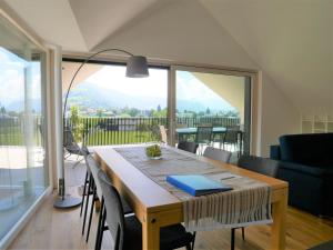 a dining room table with a view of a balcony at Penthouse 37th HEAVEN (ca. 90m²) in Lochau