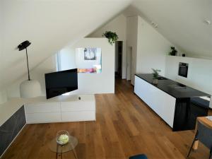 a living room with white cabinets and a tv at Penthouse 37th HEAVEN (ca. 90m²) in Lochau