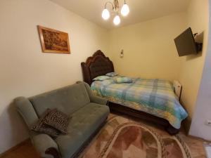 a living room with a couch and a bed at Atgiris in Palanga