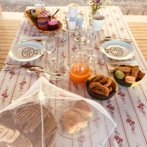 a table with a table cloth with food on it at nido d'amore in Dernice