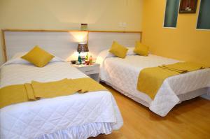 Postel nebo postele na pokoji v ubytování Kuna Hotel