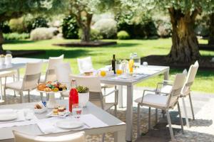 a group of tables with food and drinks on them at Donna Carmela Resort & Lodges in Riposto