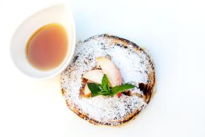 a piece of bread with a cup of tea at Donna Carmela Resort & Lodges in Riposto