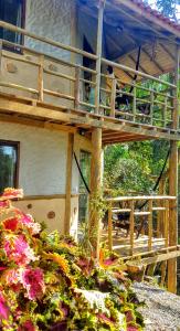 a balcony of a house with flowers in front of it at Hospedagem Casa Maracujá in Trindade