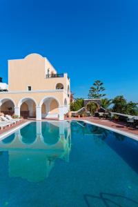 a large swimming pool in front of a building at Aelia by Eltheon in Imerovigli