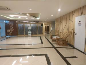 a lobby with a waiting area with chairs at Grand Kamala Lagoon By Mitra Propertindo in Bekasi +33 photos