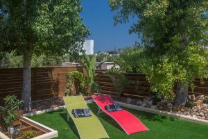 two skateboards sitting on the grass in a garden at Ariella Villa in Protaras