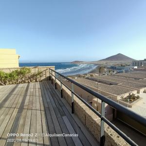 a balcony with a view of the beach at alquilaencanarias El Medano Spectacular terrace and sea views A in El Médano