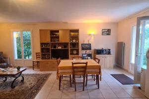 a large living room with a table and chairs at Petite maison aux abords de Bagnères de Bigorre in Bagnères-de-Bigorre