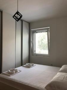 a bedroom with a bed with two towels on it at Apartman Tijana in Budva