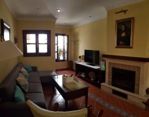 a living room with a couch and a fireplace at Ramón y Cajal in Estepona