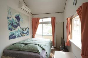 a bedroom with a bed and a large window at Garden house Ozasa - Apartment STAY in Fukuoka