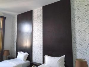 Postel nebo postele na pokoji v ubytování Ginasuite Kompleks27 Hotel
