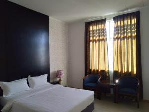 Postel nebo postele na pokoji v ubytování Ginasuite Kompleks27 Hotel
