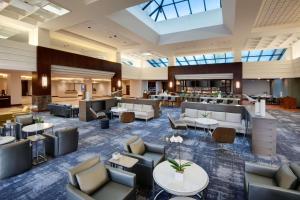 a lobby with couches and tables in a hotel at Hyatt Regency Dulles in Herndon