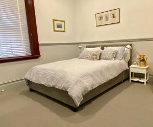 a bedroom with a bed and a window at 44 THE LANE in Mudgee