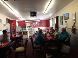 a group of people sitting at tables in a restaurant at Bluff Hotel in Bluff