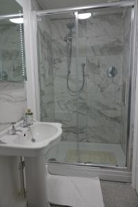 a bathroom with a shower and a sink and a shower at Kirkgate House in Knaresborough