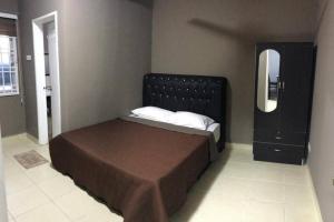a bedroom with a bed with a mirror and a dresser at River View with Pool 3-bedroom - Yusmah Riverview in Kota Bharu