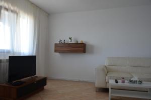 a living room with a couch and a tv at Apartament bell confort in Tulcea