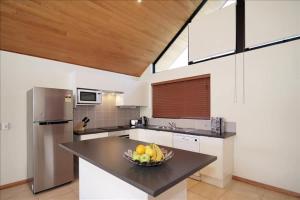 a kitchen with a bowl of fruit on a counter at Swan River Apartment in Perth