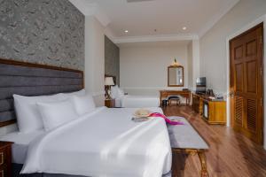 Postel nebo postele na pokoji v ubytování AVS Hotel Phu Quoc