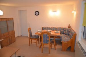 a living room with a table and a couch at FeWo Dana und Ralf in Nentershausen +3 photos