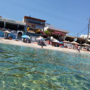 a body of water with a beach and buildings at Buganvilla Sea View apts in Agia Pelagia