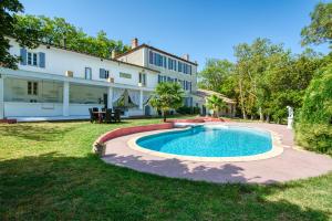 a swimming pool in the yard of a house at Château de Lavail in Labastide-dʼAnjou