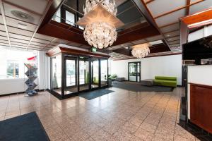 a lobby with two chandeliers in a building at Thon Partner Hotel Victoria Hamar in Hamar