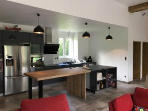 a kitchen with a wooden table in a room at Maison Eskola in Barcus +15 photos