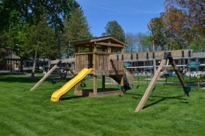a playground with a slide and a play tower at Amber's Inn and Suites in Wisconsin Dells