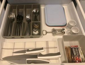 a drawer filled with utensils and a knife and fork at Angel Suites in Nicosia