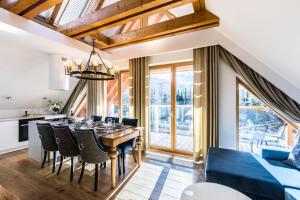 a dining room with a table and chairs at Luxury Apartments in Zakopane