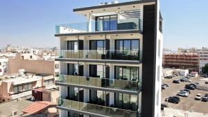 a building with balconies on the side of it at Jimmy's Suites in Larnaca