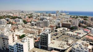 an aerial view of a city with buildings and the ocean at Jimmy's Suites in Larnaca