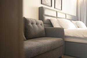 a chair in a room with a bed at Jimmy's Suites in Larnaca