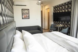 a hotel room with a bed and a table at Jimmy's Suites in Larnaca