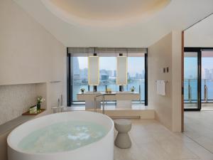 a bath room with a large tub and a large window at InterContinental Yokohama Pier 8, an IHG Hotel in Yokohama