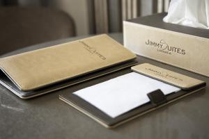 a wallet and a phone on a table next to a box at Jimmy's Suites in Larnaca