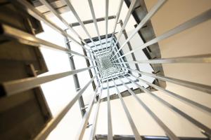 a metal spiral staircase in a building at Jimmy's Suites in Larnaca