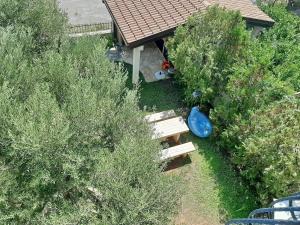 an overhead view of a backyard with a bench and trees at Apartments Trstenica in Orebić