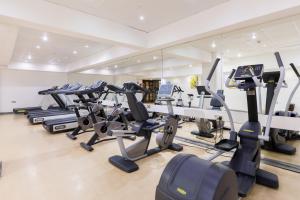 a gym with a row of tread machines at Golden Bay Beach Hotel in Larnaca
