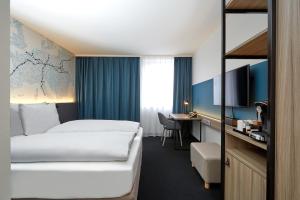 TV a/nebo společenská místnost v ubytování H4 Hotel Leipzig
