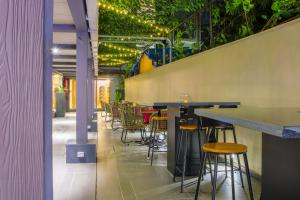 a bar with chairs and tables in a restaurant at T24 Retro in Mumbai